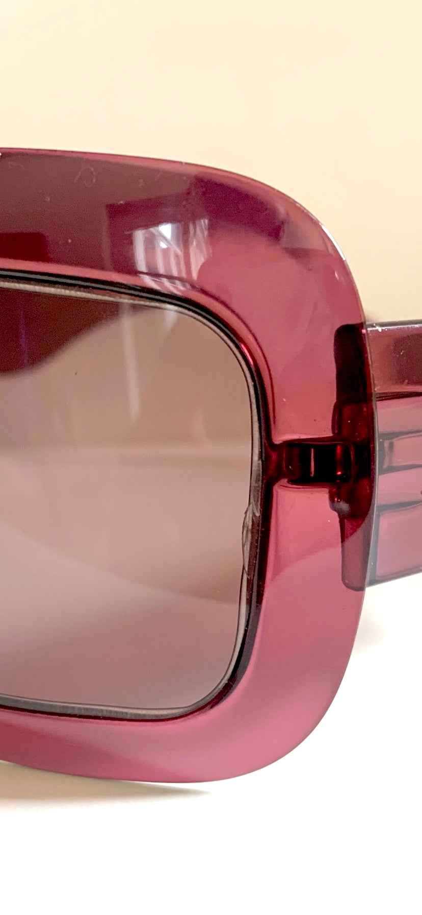 Dior sunglasses with a pink frame and dark lenses on a white background