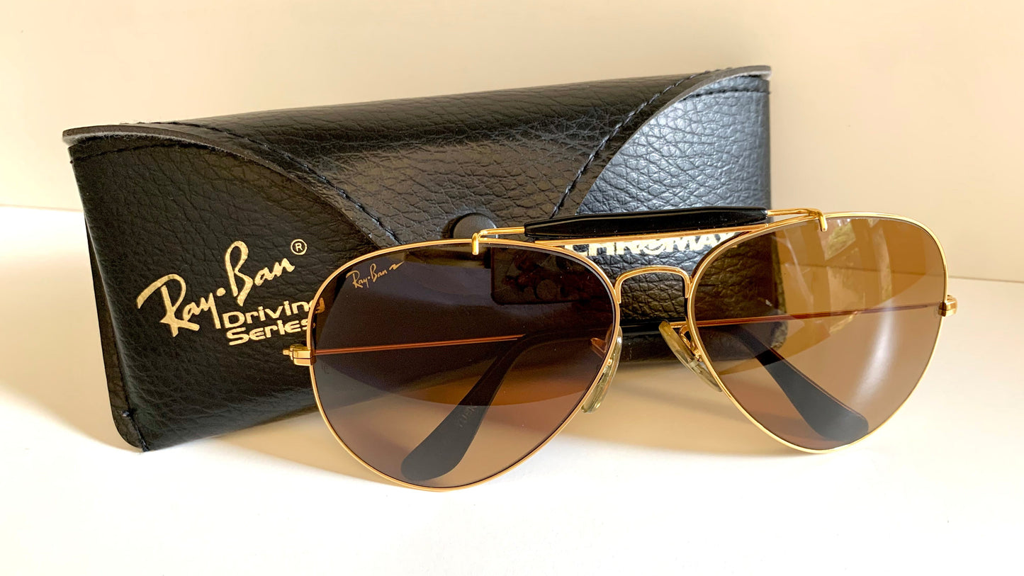 Ray Ban Chromax outdoorsman Gold-framed sunglasses with golden lenses on a white background
