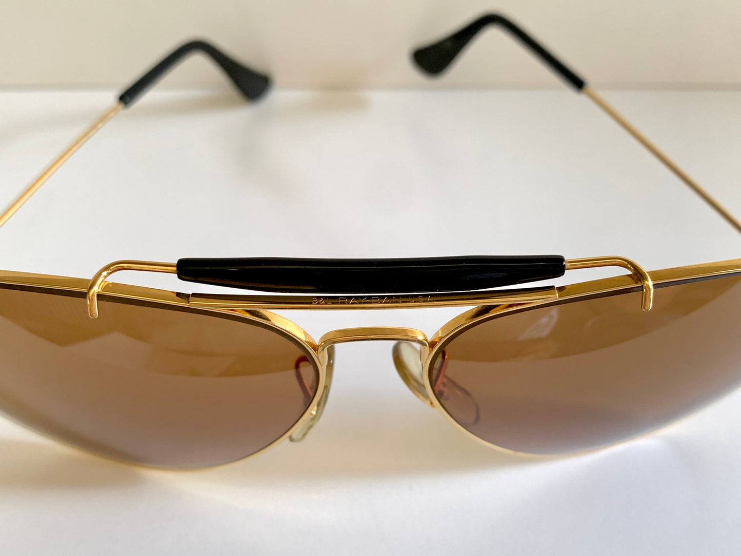 Ray Ban Chromax outdoorsman Gold-framed sunglasses with golden lenses on a white background