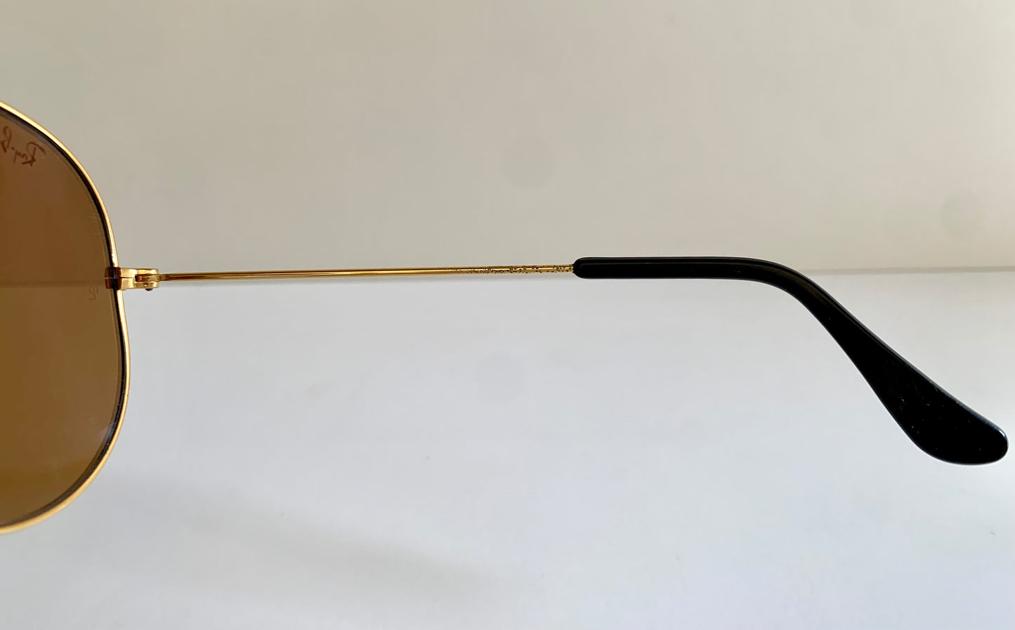 Ray Ban Chromax outdoorsman Gold-framed sunglasses with golden lenses on a white background