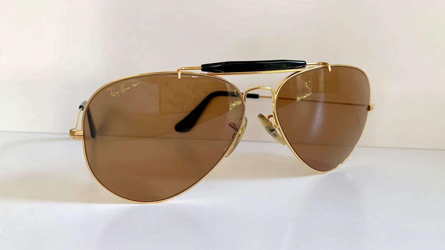 Ray Ban Chromax outdoorsman Gold-framed sunglasses with golden lenses on a white background