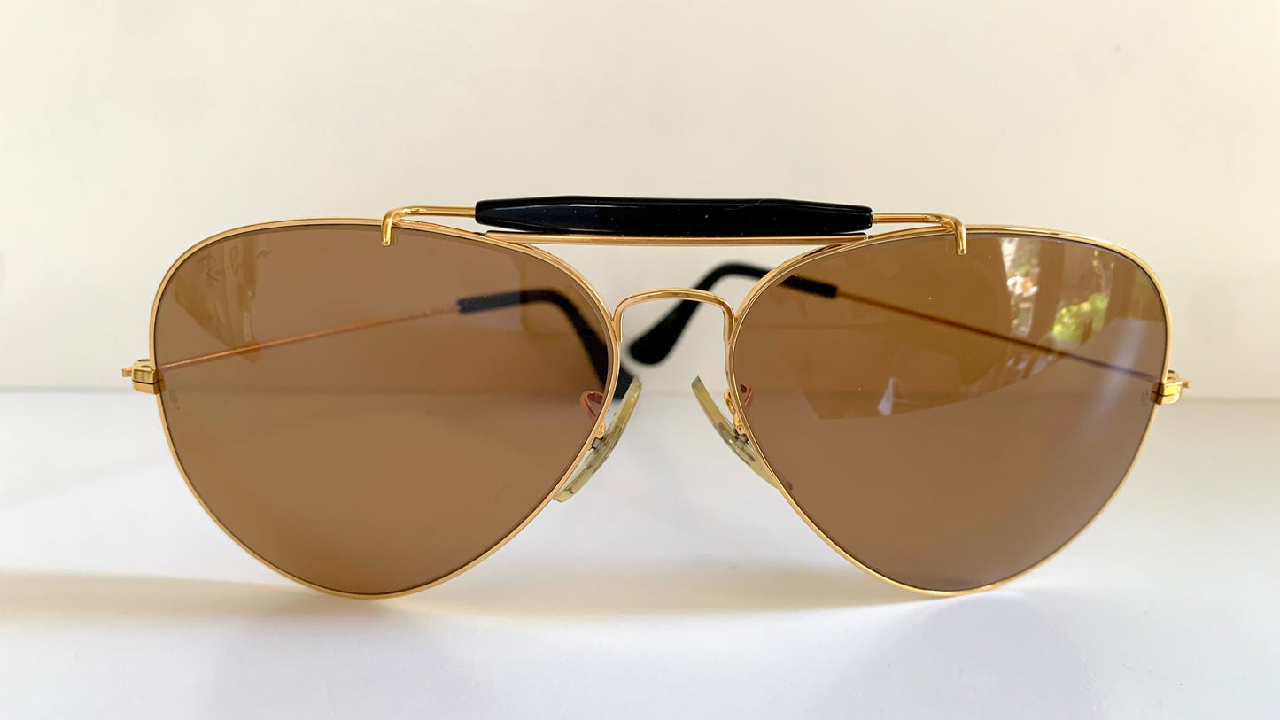 Ray Ban Chromax outdoorsman Gold-framed sunglasses with golden lenses on a white background