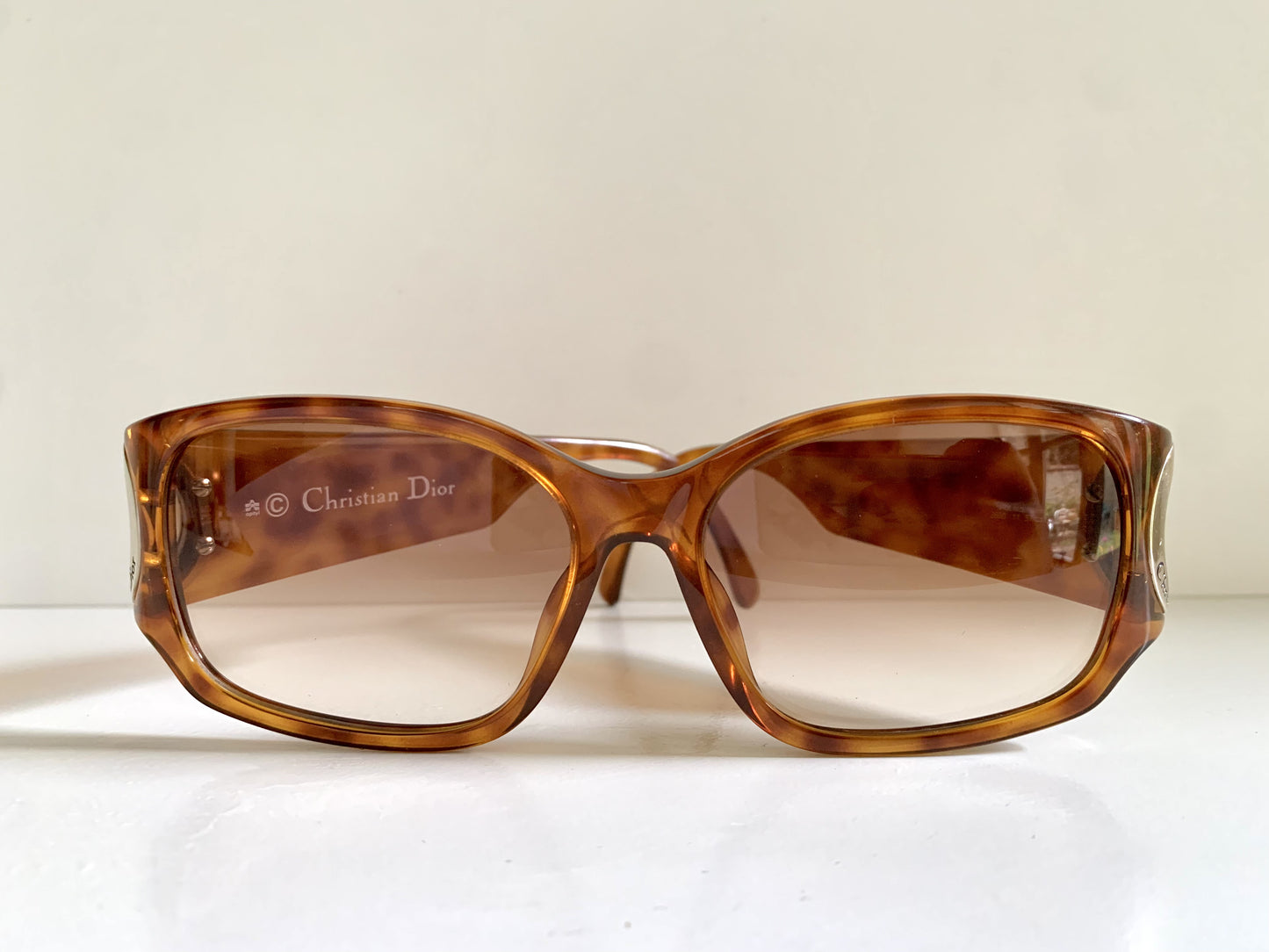Brown sunglasses with Dior logo on a white background