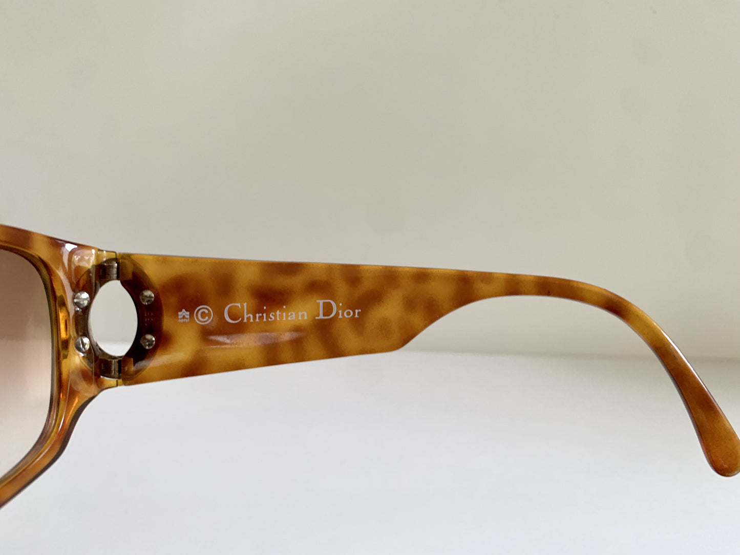 Brown sunglasses with Christian Dior branding on a white background