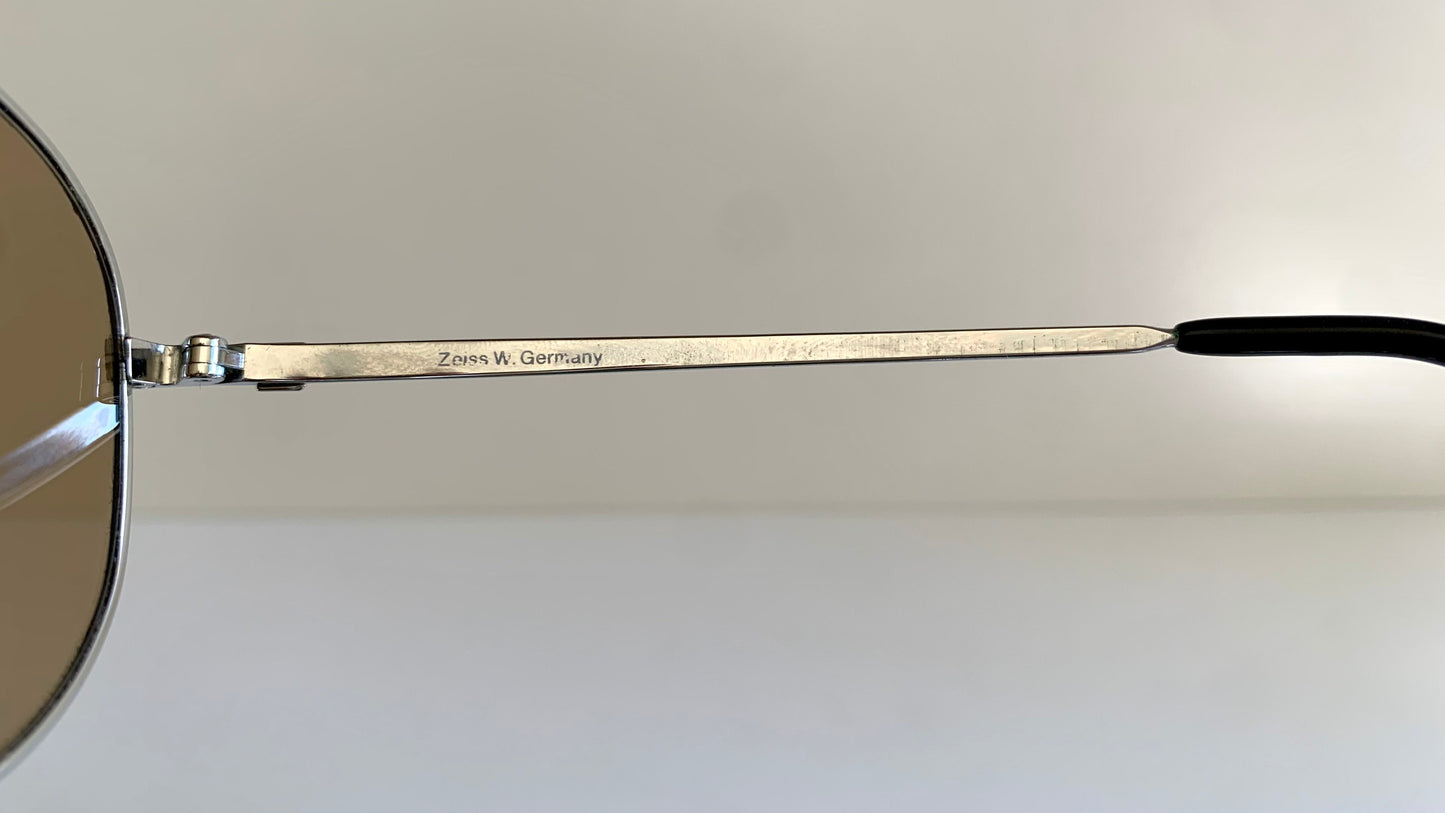 Sunglasses with a visible brand name on the arm against a light background