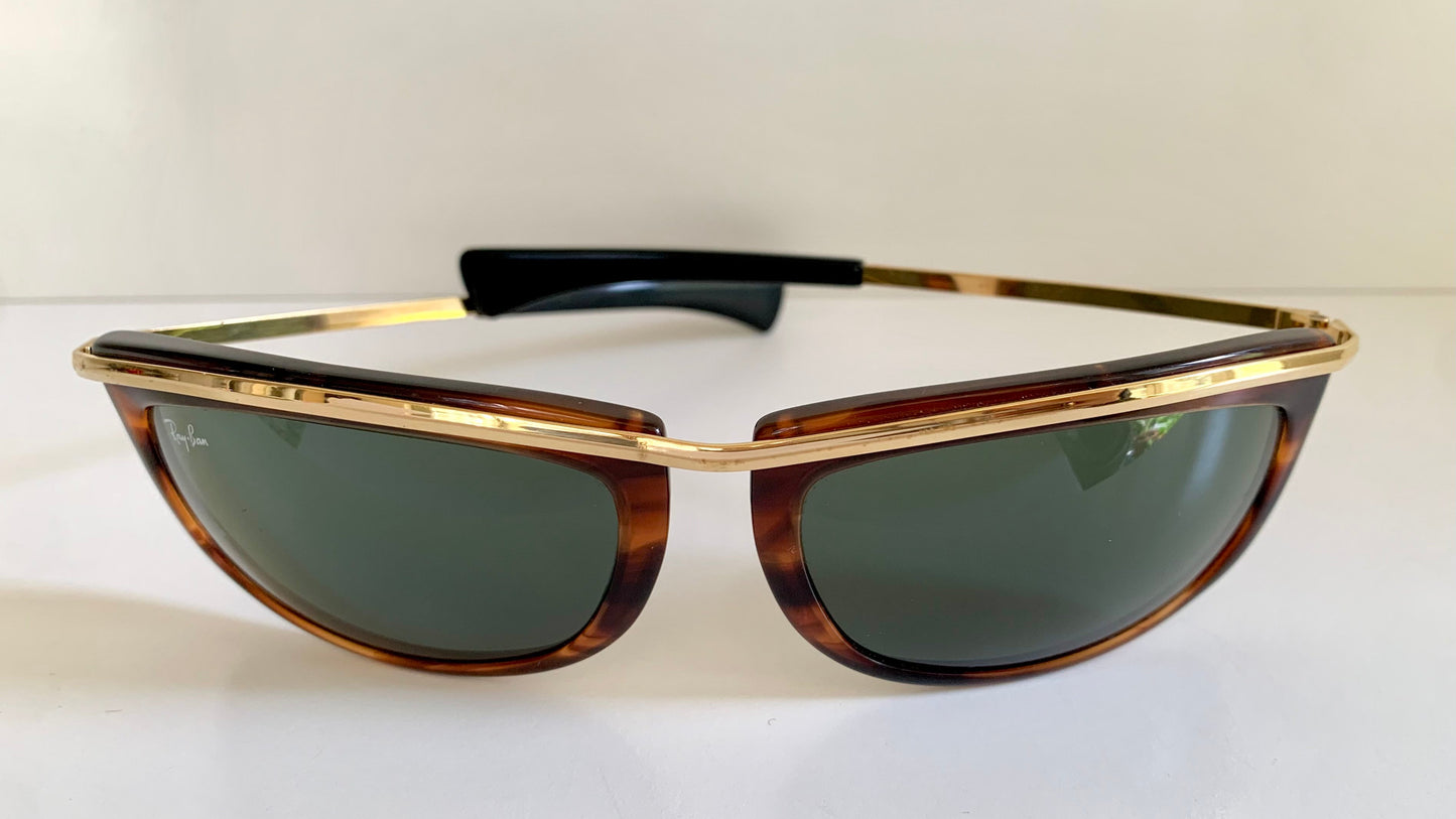 Sunglasses with tortoiseshell frame and dark lenses on a white background
