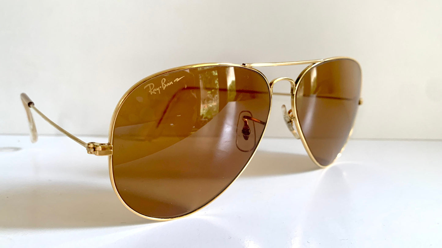 Ray Ban Chromax Aviator sunglasses with gold frame and brown lenses on a white background