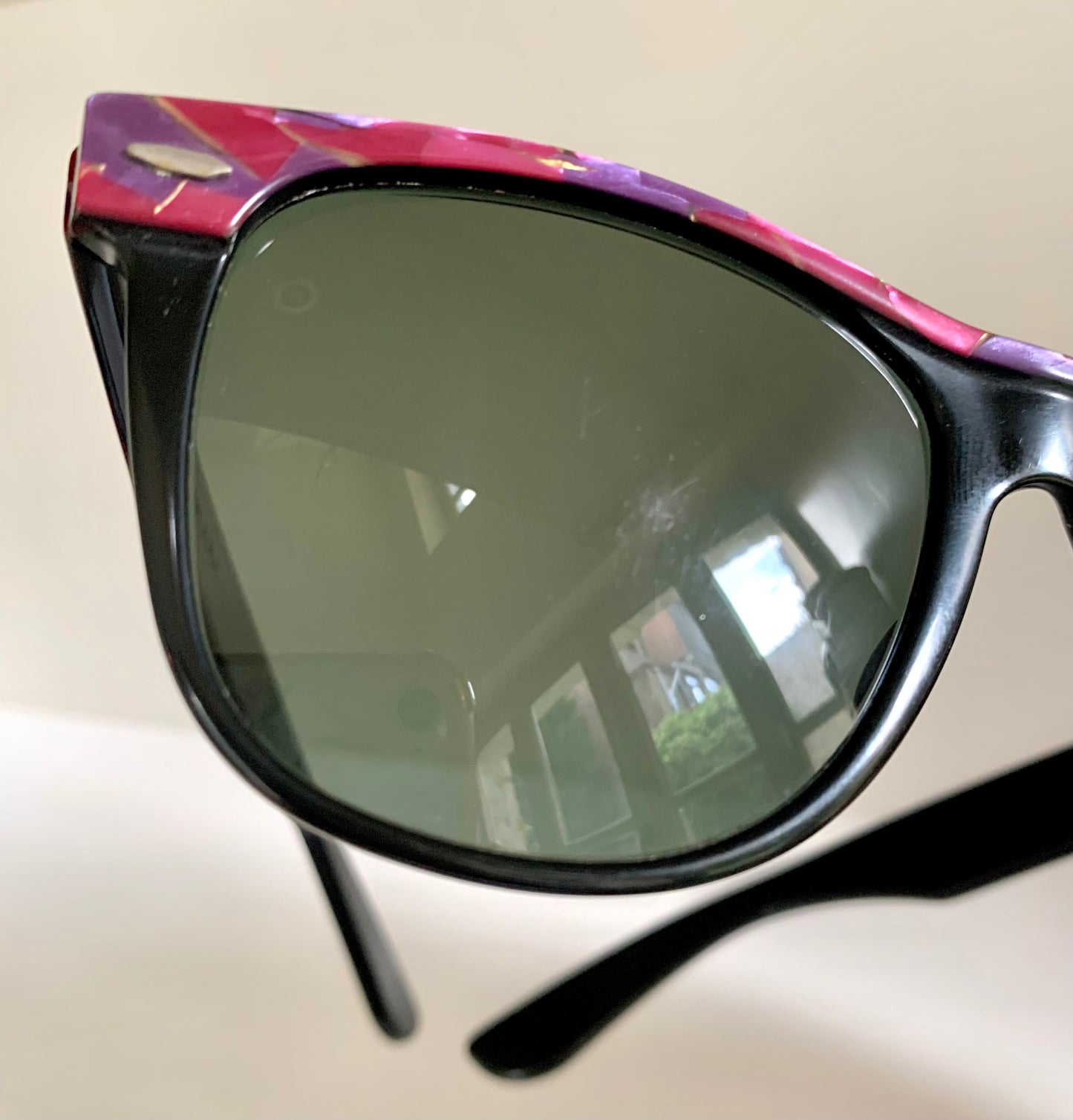 Ray Ban Sreet neat sunglasses with pink mosaice frame on a white surface