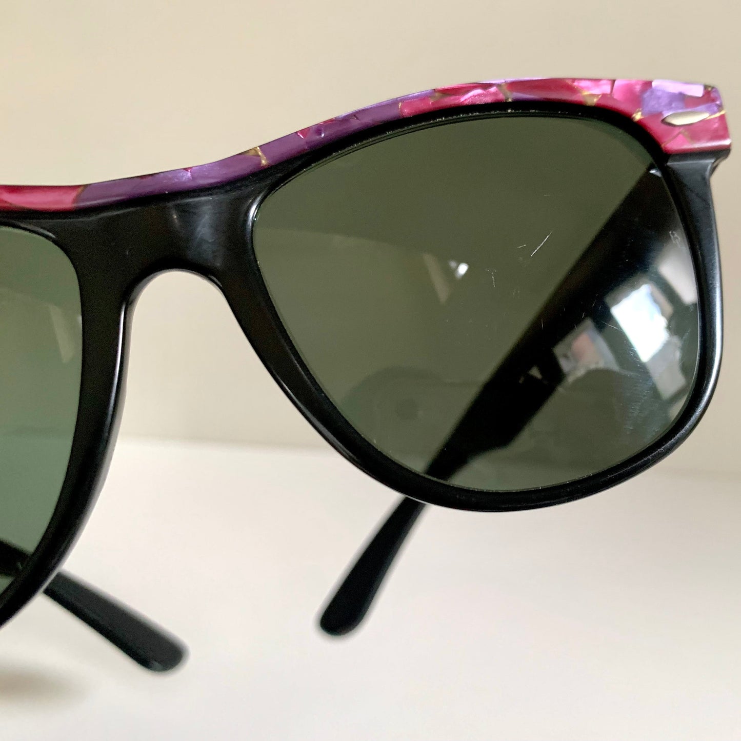 Ray Ban Sreet neat sunglasses with pink mosaice frame on a white surface