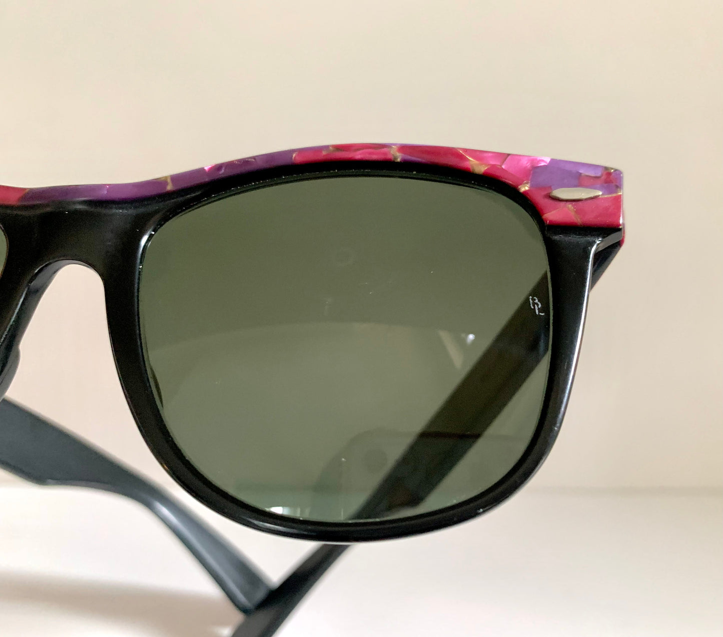 Ray Ban Sreet neat sunglasses with pink mosaice frame on a white surface