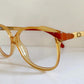 Yellow Dior eyeglasses on a white background