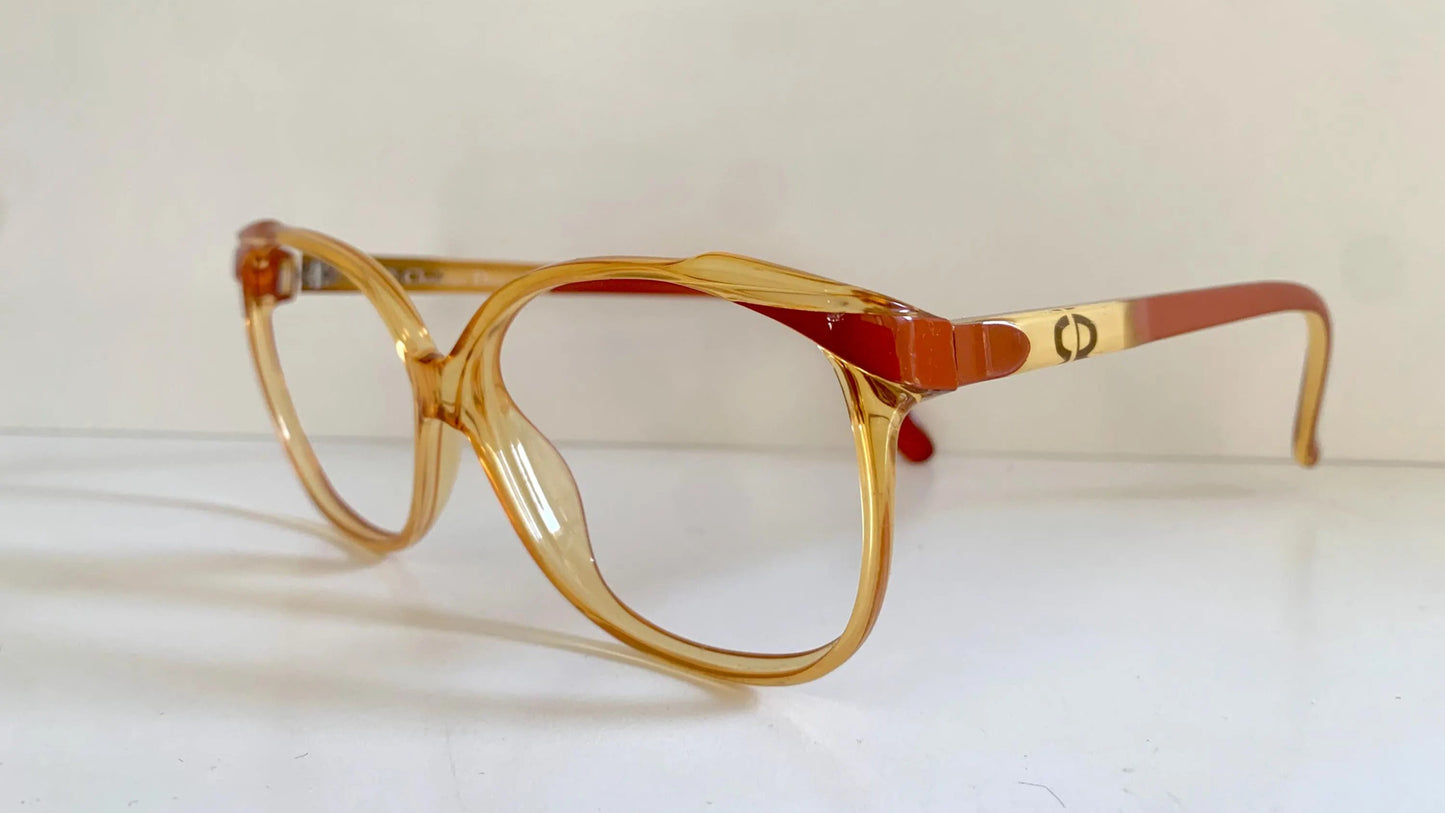 Yellow Dior eyeglasses on a white background