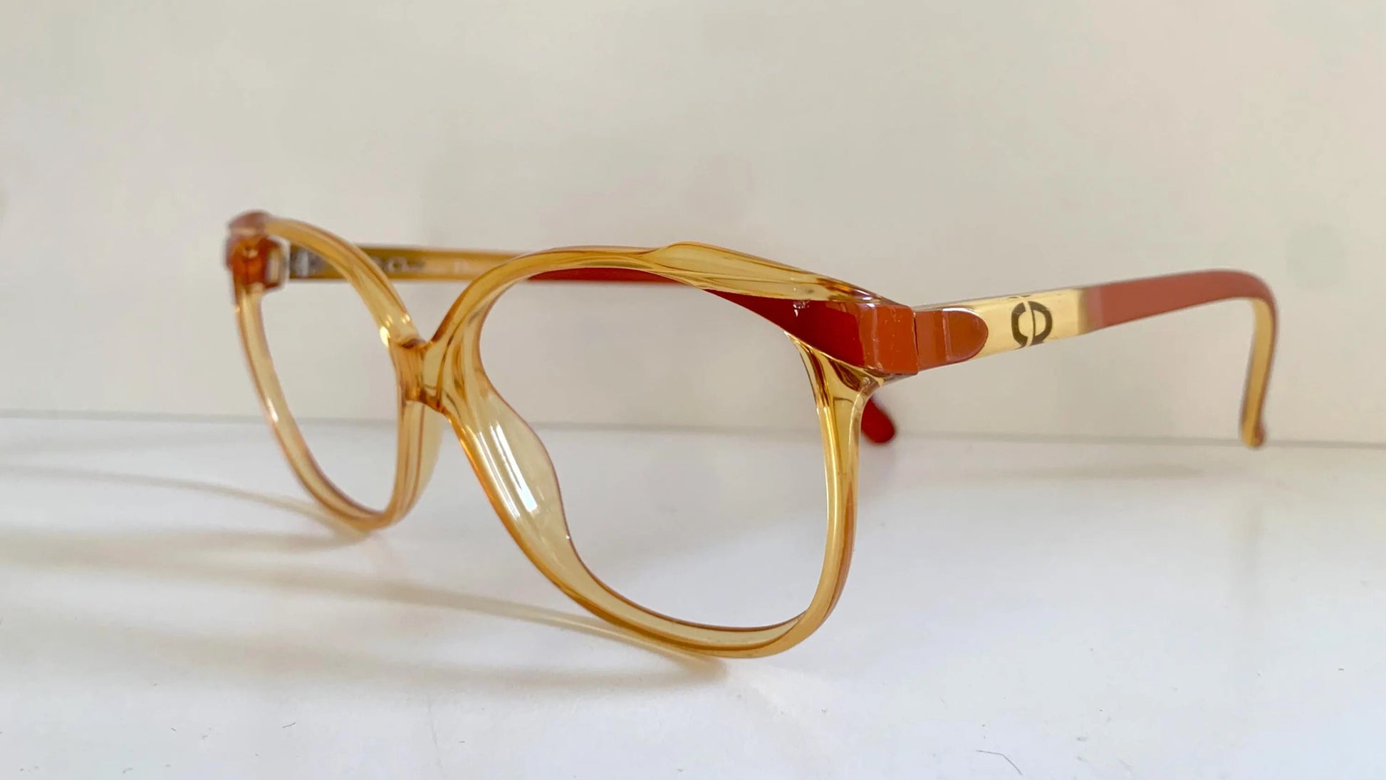 Yellow Dior eyeglasses on a white background