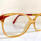 Pair of Christian Dior eyeglasses with a yellow frame on a white background