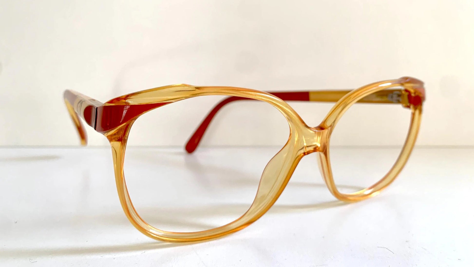 Pair of Christian Dior eyeglasses with a yellow frame on a white background