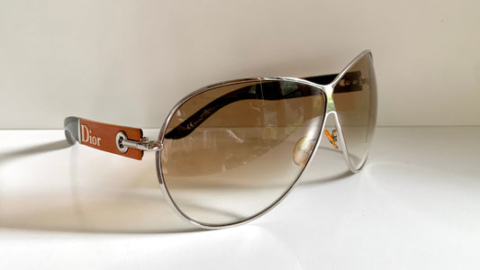 Christian Dior sunglasses with a visible brand logo on a white background