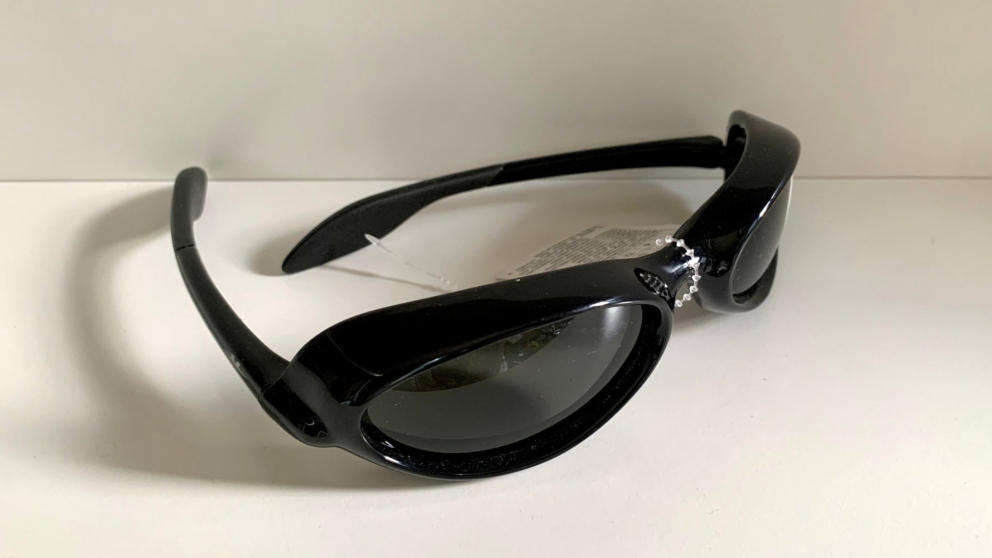 Vuarnet Extreme black sunglasses with a visible brand logo on a white background