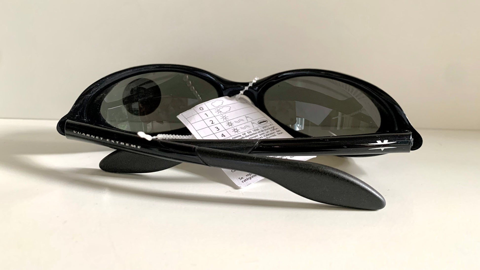 Vuarnet Extreme black sunglasses with a visible brand logo on a white background