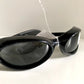 Vuarnet Extreme black sunglasses with a visible brand logo on a white background