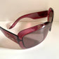 Dior sunglasses with a pink frame and dark lenses on a white background