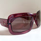 Dior sunglasses with a pink frame and dark lenses on a white background