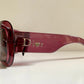 Dior sunglasses with a pink frame and dark lenses on a white background