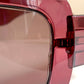 Dior sunglasses with a pink frame and dark lenses on a white background