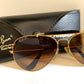 Ray Ban Chromax outdoorsman Gold-framed sunglasses with golden lenses on a white background