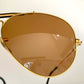 Ray Ban Chromax outdoorsman Gold-framed sunglasses with golden lenses on a white background