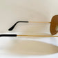 Ray Ban Chromax outdoorsman Gold-framed sunglasses with golden lenses on a white background