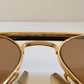 Ray Ban Chromax outdoorsman Gold-framed sunglasses with golden lenses on a white background