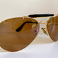 Ray Ban Chromax outdoorsman Gold-framed sunglasses with golden lenses on a white background,