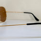 Ray Ban Chromax outdoorsman Gold-framed sunglasses with golden lenses on a white background