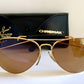 Ray Ban Chromax outdoorsman Gold-framed sunglasses with golden lenses on a white background, accompanied by a black case.