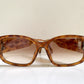 Brown sunglasses with Dior logo on a white background