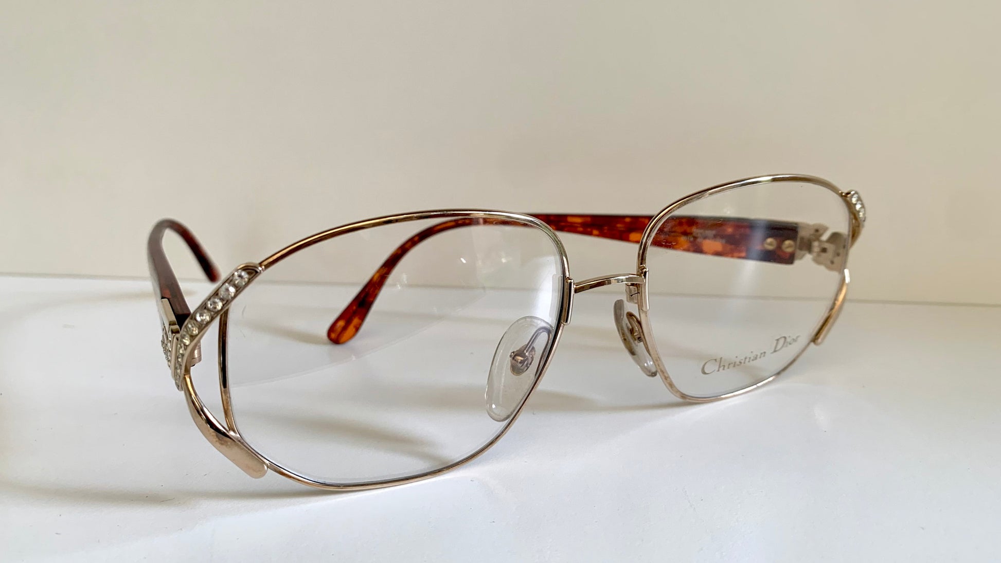 Eyeglasses with a tortoiseshell frame on a white surface