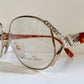 Vintage Dior eyeglasses with decorative frame on a light background