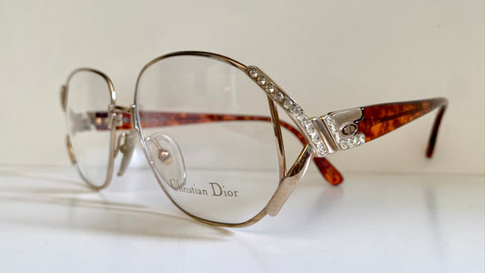 Vintage Dior eyeglasses with decorative frame on a light background