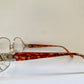Tortoiseshell eyeglasses with decorative frame on a white background