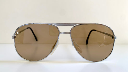 Aviator sunglasses with brown lenses on a white background