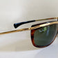 Ray-Ban sunglasses with gold frame and tortoiseshell arms on a white background