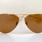 Ray Ban Chromax Aviator sunglasses with gold frame and brown lenses on a white background