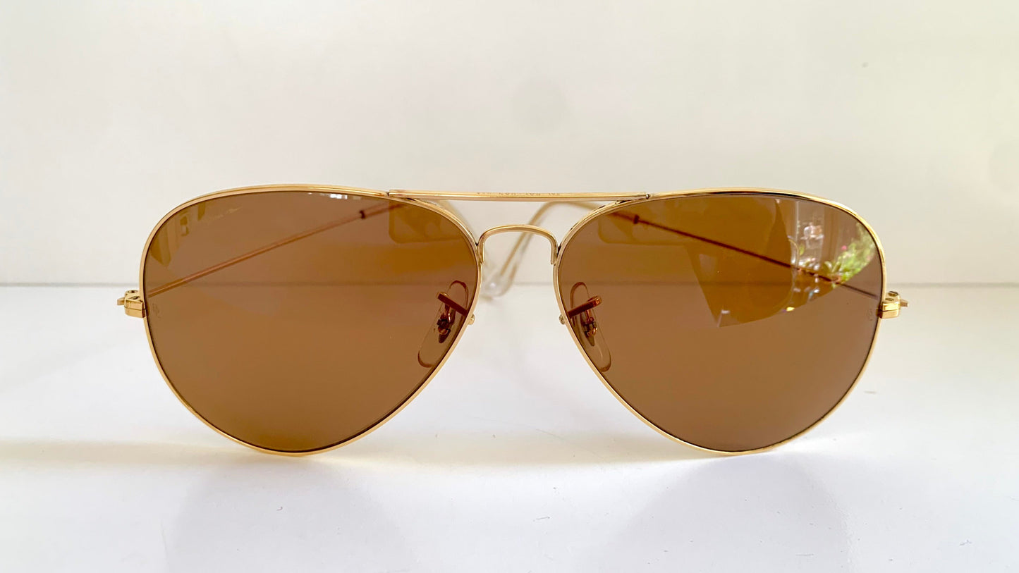 Ray Ban Chromax Aviator sunglasses with gold frame and brown lenses on a white background
