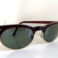 Sunglasses with dark lenses and tortoiseshell frame on a white background