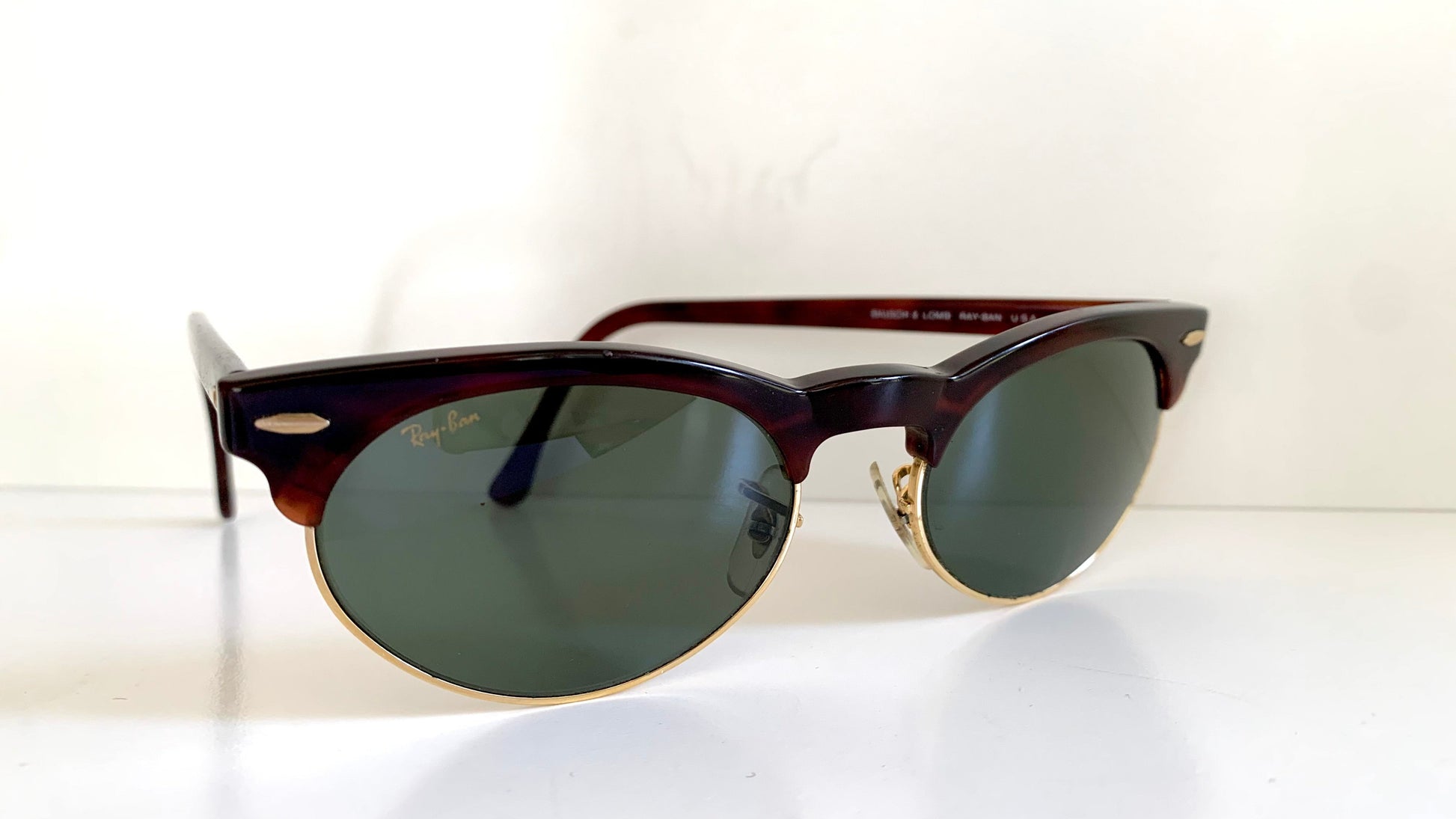 Sunglasses with dark lenses and tortoiseshell frame on a white background