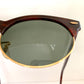 Sunglasses with dark lenses and brown frame on a white background