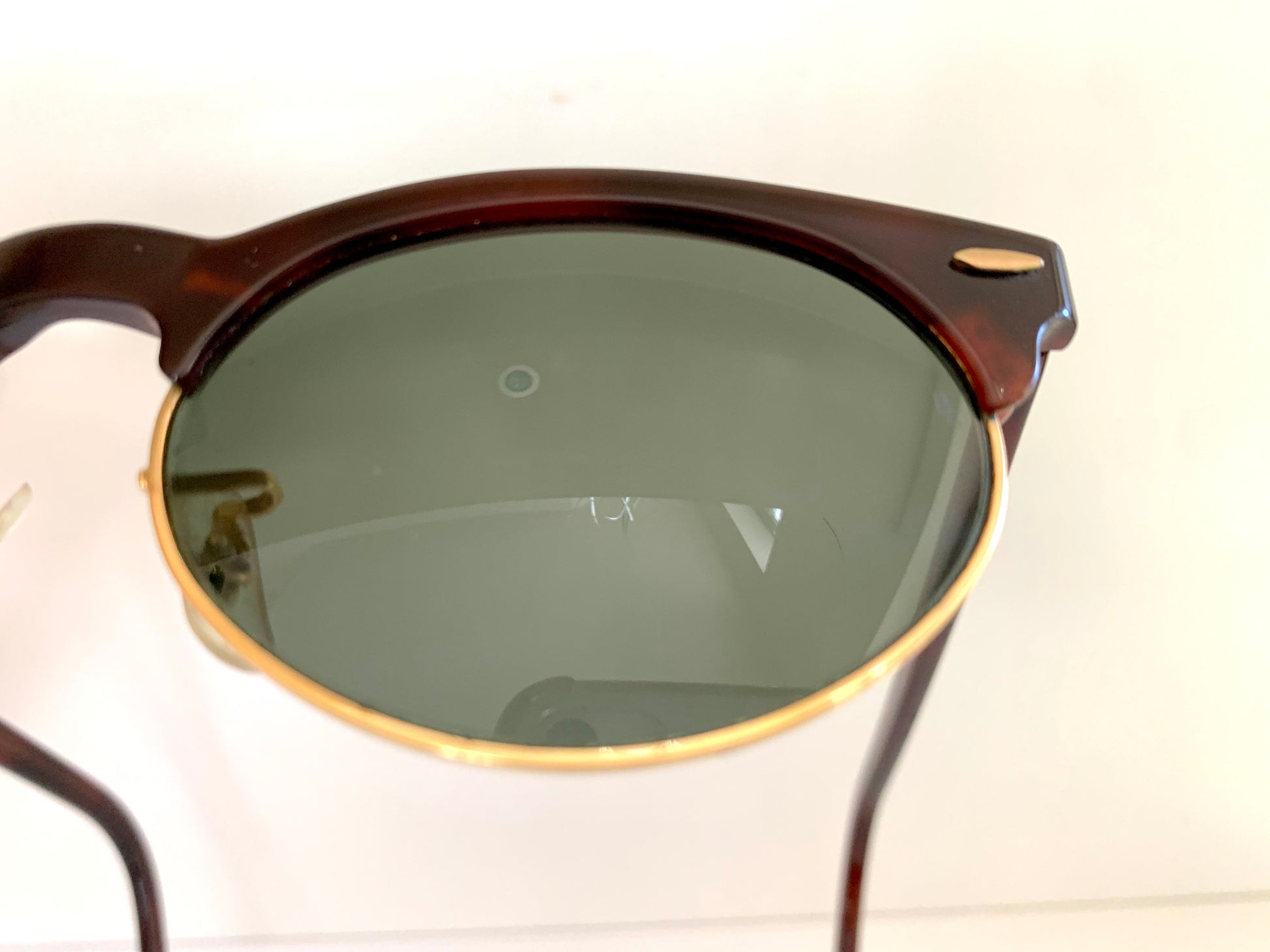 Sunglasses with dark lenses and brown frame on a white background