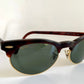 Sunglasses with dark lenses and brown frame on a white background