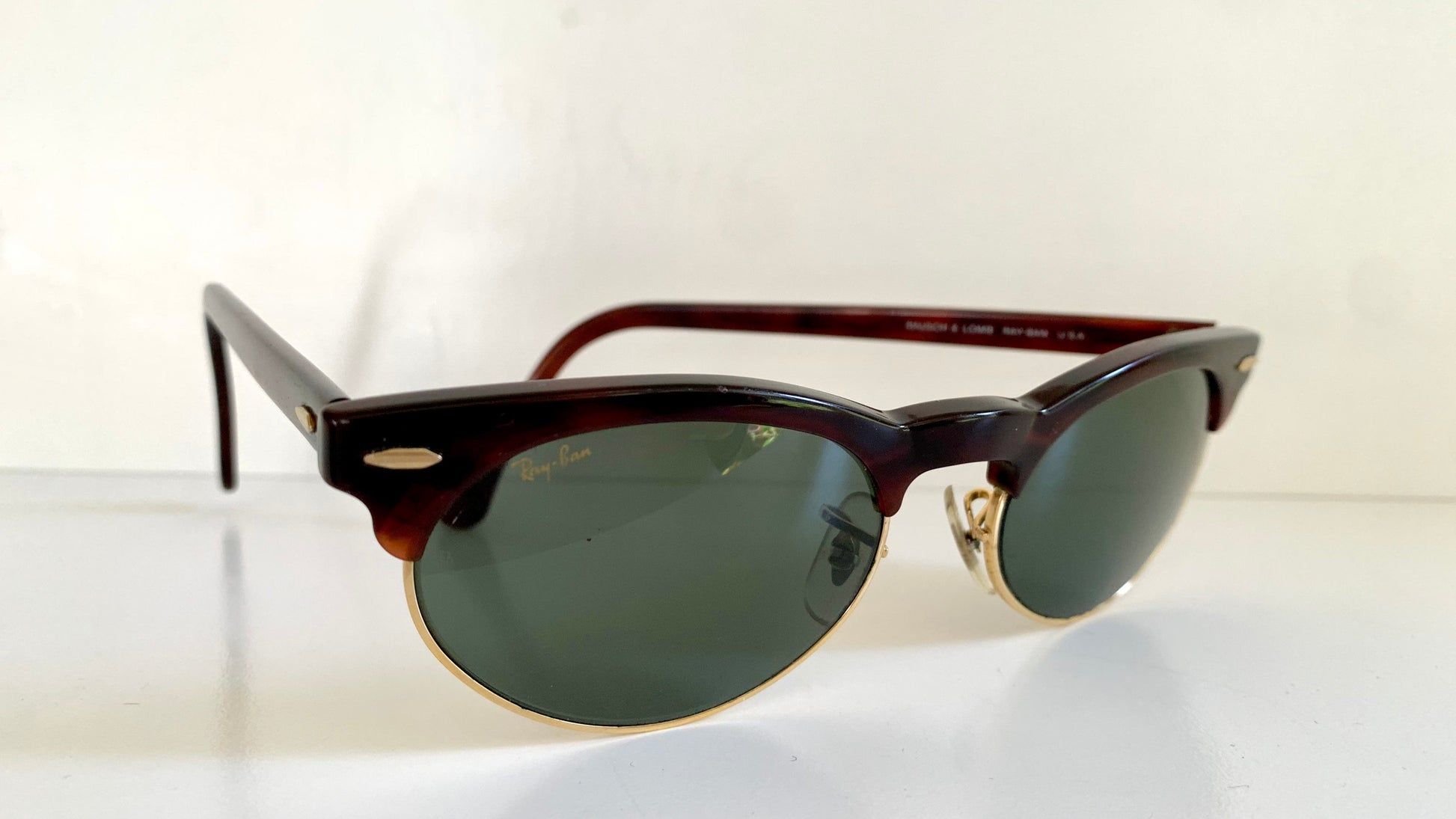 Sunglasses with dark lenses and brown frame on a white background