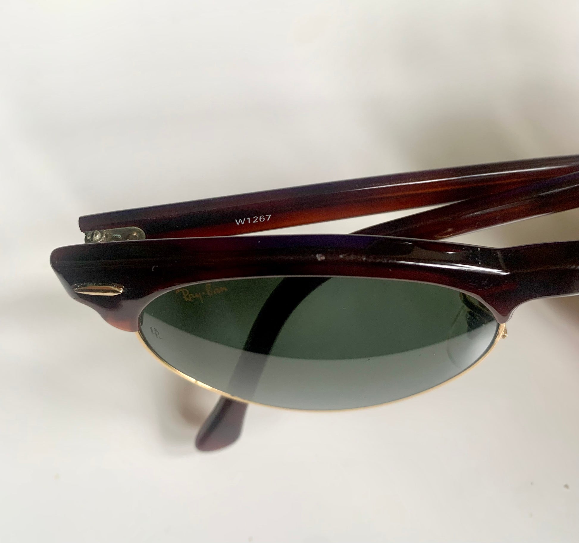 Pair of sunglasses with a 'Ray-Ban' logo on a white background